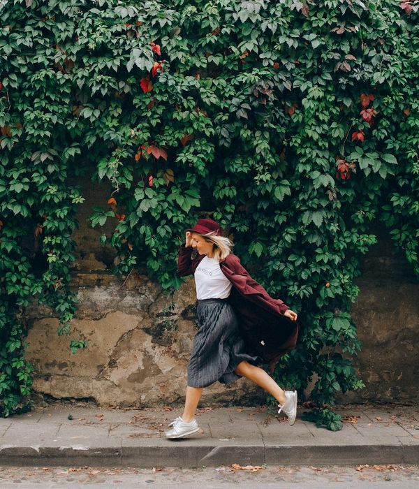 Woman feeling energetic and vibrant in a natural setting.